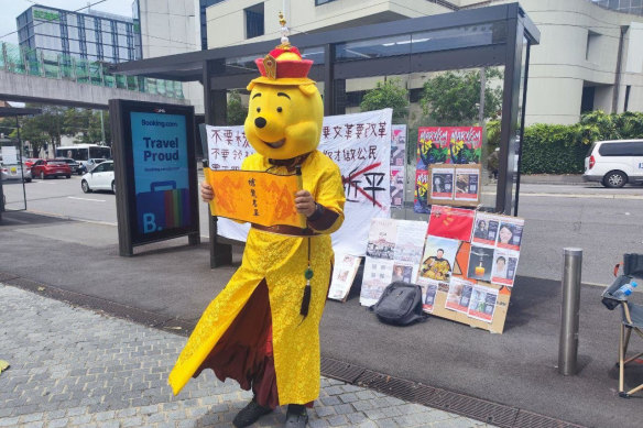 Chinese international student Aaron dressed as Winnie the Pooh as part of his protest against Chinese President Xi Jinping at a bus stop outside the entrance to the University of Sydney in February 2023.