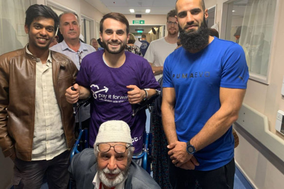 Richmond footballer Bachar Houli (right) visits victims of the Christchurch massacre in hospital. 