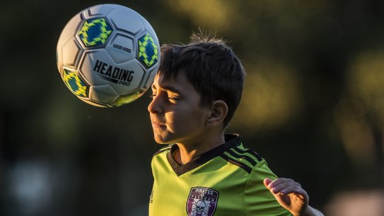 Alex Nitsas, 7, from the Ashfield Pirates, practises heading with a special soft ball.
