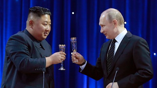 North Korean leader Kim Jong Un raises a toast with Russian President Vladimir Putin.