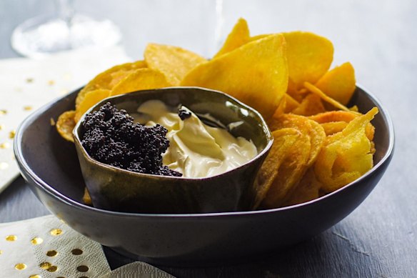 Kettle chips with champagne creme fraiche and caviar. Christmas canape recipes for Good Food online feature December 2018. Please credit Katrina Meynink.