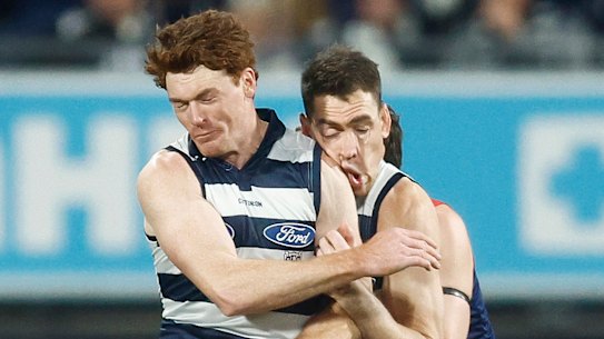 Gary Rohan of the Cats makes accidental contact with Jeremy Cameron of the Cats.