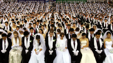 More than 4000 couples get married in a ceremony arranged by the Reverend Sun Myung Moon’s Unification Church in South Korea in 2005.