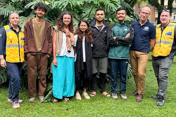 Nepalese flood survivor Cara Severino with Australian consular officials in Nepal.