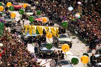 Returning Olympic stars parade down Swanston Street.
