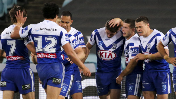 Pats all round: The Bulldogs celebrate a Nick Meaney try during their win over the Tigers at ANZ Stadium.