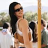 Kendall Jenner in the unofficial Coachella uniform carrying a Kate Spade New York handbag.