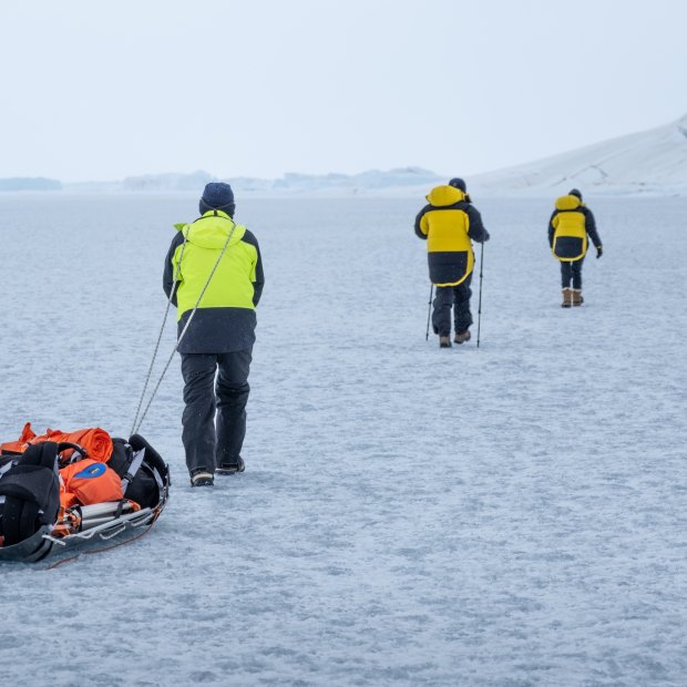 Hauling gear across a frozen epishelf lake back to camp.