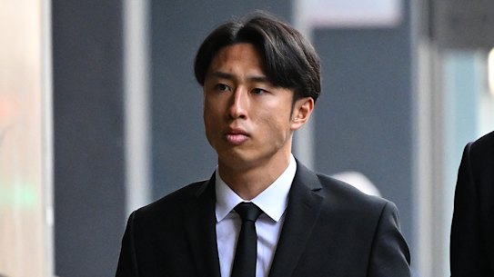 Western United player Riku Danzaki (left) arrives at Melbourne Magistrates’ Court to face allegations of deliberately receiving yellow cards in a match.