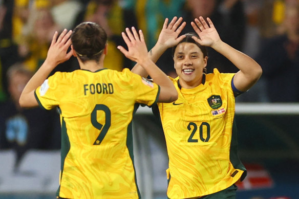 Australia’s Sam Kerr high-fives Caitlin Foord after coming on as a substitute.