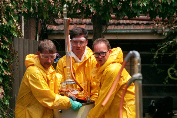 Clandestine lab experts wearing protective suits remove evidence from Tony Mokbel's speed lab in 1997.   