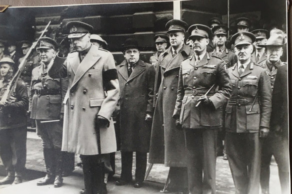 Major Todd (fifth from left) stands behind Victorian governor Sir Winston Dugan as he acknowledges returning troops of the 17th Brigade, AIF, in front of Melbourne Town Hall in 1944.