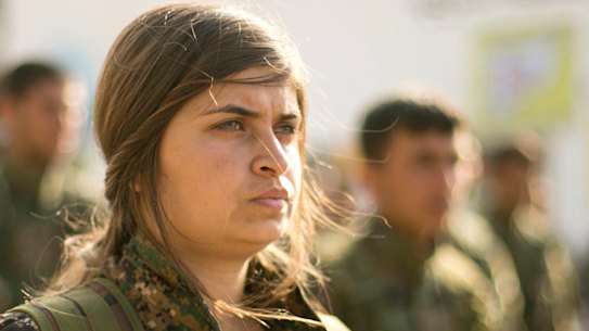 US-backed Syrian Democratic Forces stand in formation at a ceremony to mark their defeat of Islamic State militants in Baghouz.