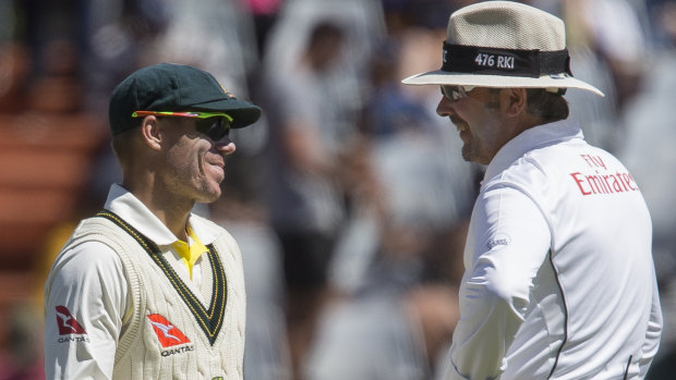 David Warner talks to an umpire on the fourth day of the third Test in Cape Town.