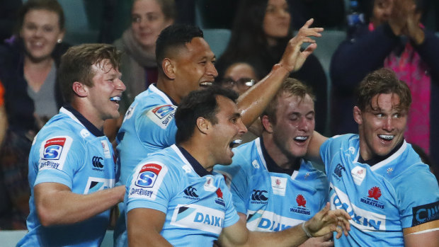 Stopping the rot: The Waratahs celebrate a try during their big win against the Highlanders, the first by an Australian side against Kiwi opposition in two years.
