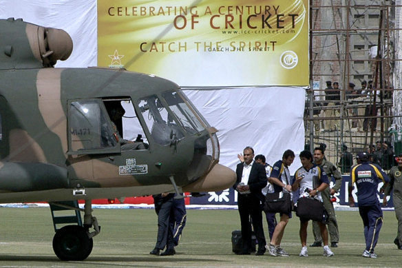 Sri Lankan officials and players board a helicopter at Gaddafi Stadium after the 2009 attack.