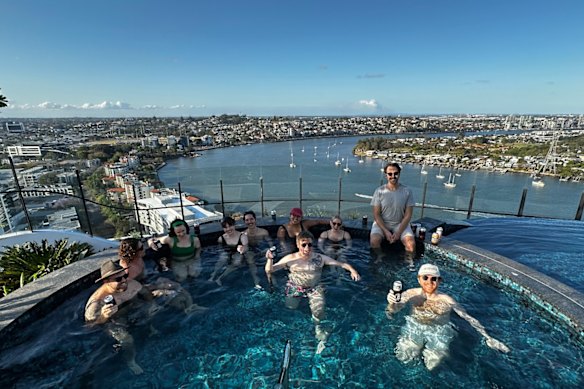 Friends relaxing in a rooftop pool in Newstead.