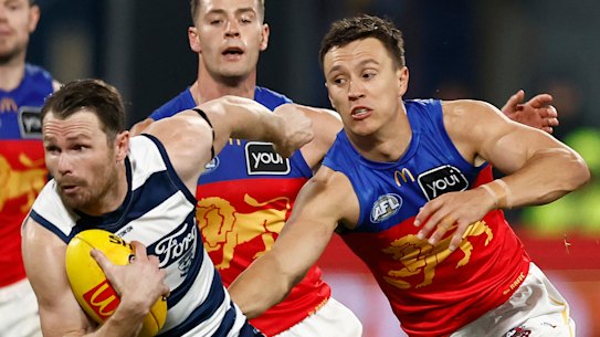 Lions star Hugh McCluggage gives chase to Geelong captain Patrick Dangerfield.