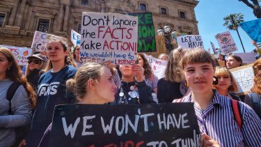 Students hold placards during Friday's climate protest in Melbourne.