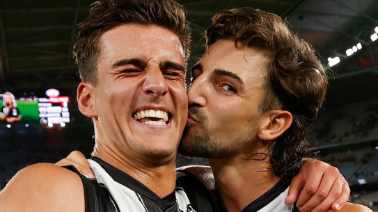 MELBOURNE, AUSTRALIA - MARCH 18: Nick Daicos (left) receives a kiss form brother Josh after the 2022 AFL Round 01 match between the St Kilda Saints and the Collingwood Magpies at Marvel Stadium on March 18, 2022 In Melbourne, Australia. (Photo by Michael Willson/AFL Photos via Getty Images)