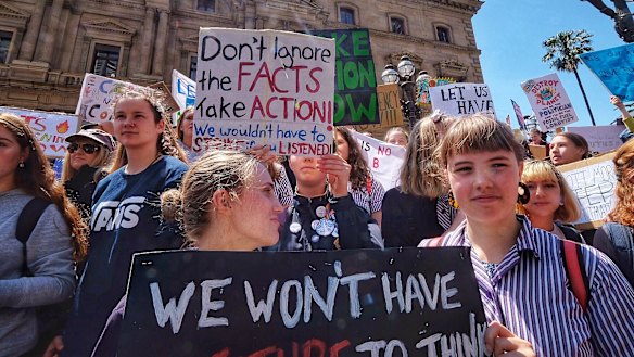 Students hold placards during Friday's climate protest in Melbourne.
