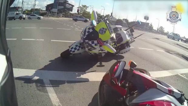 A Queensland police officer has been rammed by a motorbike moments before chasing the rider down and tackling him to the ground in Brisbane's north. 