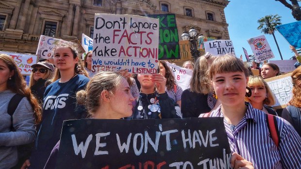 Students hold placards during Friday's climate protest in Melbourne.