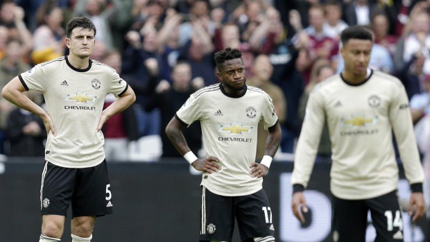 Manchester United players look on after West Ham's second goal.