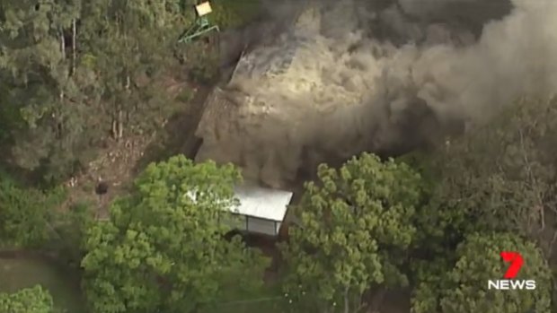 A Bardon home has gone up in flames, with thick smoke billowing from the two-storey property.