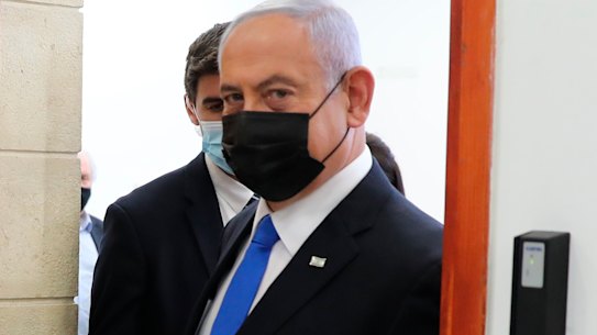 Israeli Prime Minister Benjamin Netanyahu, right, leaves court during his corruption trial on Monday.