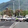 A woman is fighting for life after being struck by a police car in Cairns.