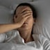 Woman feeling sick and tired in the bed.