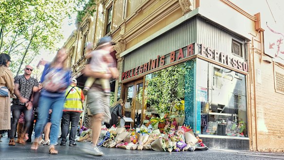 Mourners leave flowers outside Pellegrini's to remember Sisto Malaspina. 