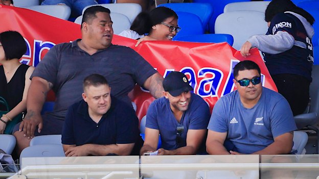 Deregistered player agent Isaac Moses (in blue shirt and black cap) sitting with the Suaalii family last month.