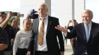 Wikileaks founder Julian Assange arrives at a US court in Saipan, flanked by former Australian prime minister Kevin Rudd.