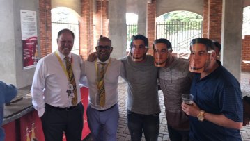 Cricket South Africa officials Clive Eksteen and Altaaf Kazi pose with spectators wearing Sonny Bill Williams masks at St George’s Park in 2018.