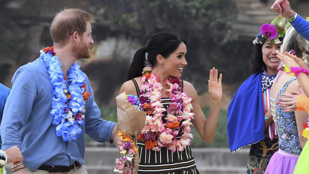 Britain's Prince Harry and Meghan, Duchess of Sussex meet a local surfing community group, known as OneWave, raising awareness for mental health and wellbeing at Bondi Beach in Sydney on Friday. 