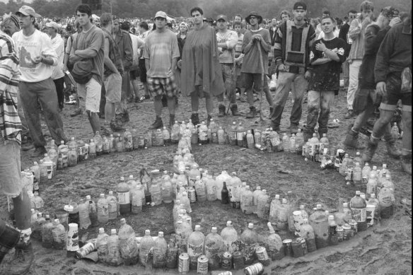 Used plastic containers are fashioned into a peace sign by spectators near the north stage at the Woodstock festival in Saugerties, New York in 1994.