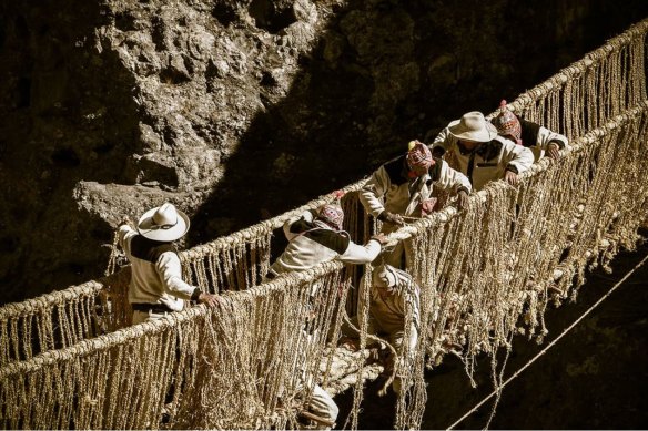 Members of the Huinchiri community rebuild an Incan hanging bridge, known as the Q’eswachaka bridge, using traditional weaving techniques in Canas, Peru.