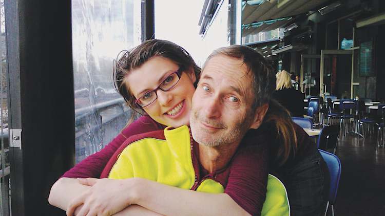 With her father.
