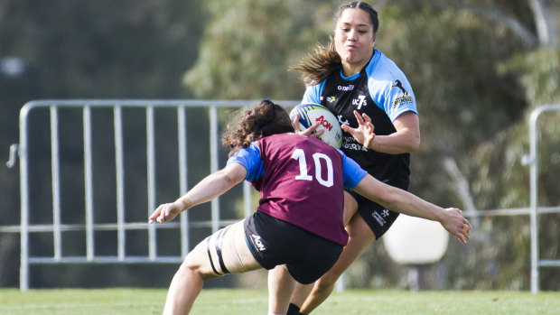 UC's Yasmin Meakes clatters into the defence.