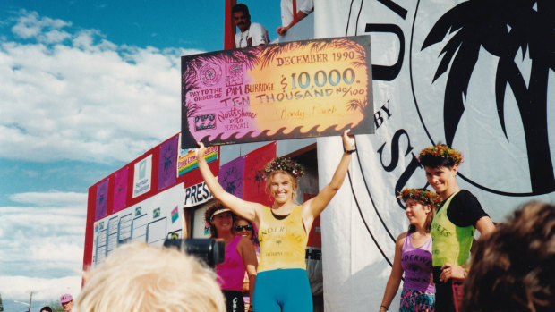 Pam Burridge collects a winner's cheque in Girls Can't Surf.