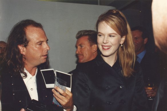 Photographer Robert Rosen shows Nicole Kidman the Polaroids he has taken of her (Sydney, 1996).