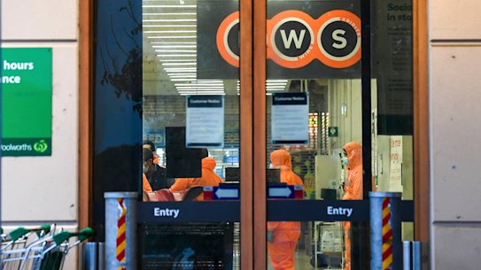 Workers prepare to deep clean a Woolworths in Epping Plaza that has been listed as a tier 1 COVID-19 exposure site on Tuesday.