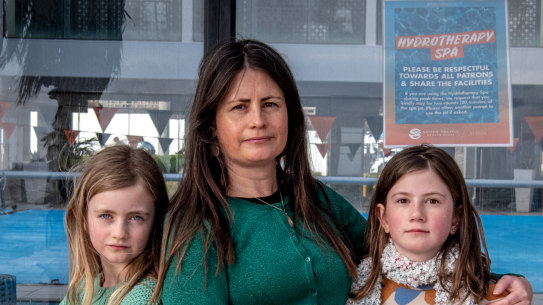 Kathryn Bowen and her daughters Isidora, 8 and Mathilde, 11, outside the St Kilda Sea Baths where they have swimming lessons when public pools are open. 