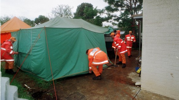 Police assisted by Emergency Services personnel working at the rear of a Housing Trust House at Salisbury North.