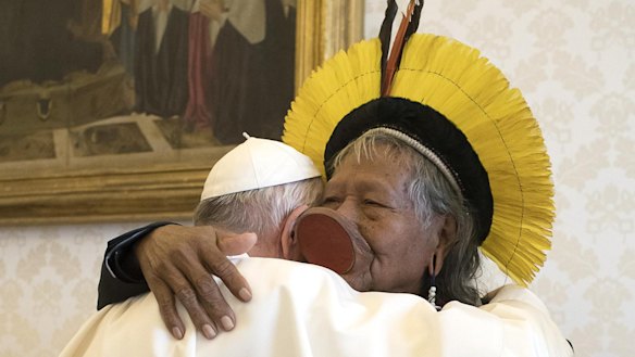 Pope Francis, left, embraces Chief Raoni Metuktire of the Kayapo Tribe in the Vatican on Monday. Raoni is travelling with a Xingu delegation to raise awareness of the threat to Amazon indigenous reserves.