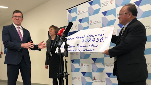 Acting Multicultural Affairs Minister Alan Tudge (left) was presented with a donation by Sunny Duong (right) in June.