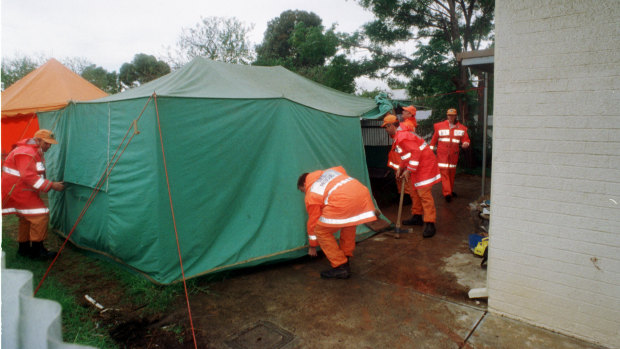 Police assisted by Emergency Services personnel working at the rear of a Housing Trust House at Salisbury North.