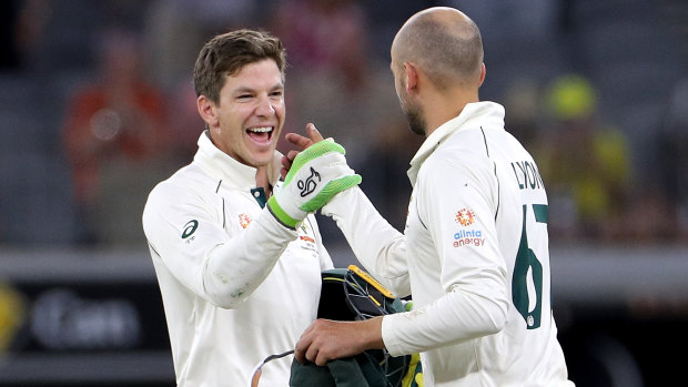 Tim Paine and Nathan Lyon celebrate victory on night four.
